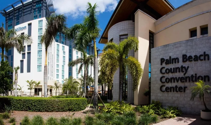 Exterior of Palm Beach County Convention Center with Hilton West Palm Beach Hotel in the background.