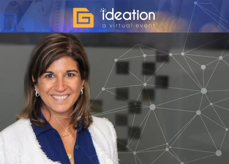 A smiling woman stands before an Ideation event graphic, embodying a professional yet approachable ambiance.