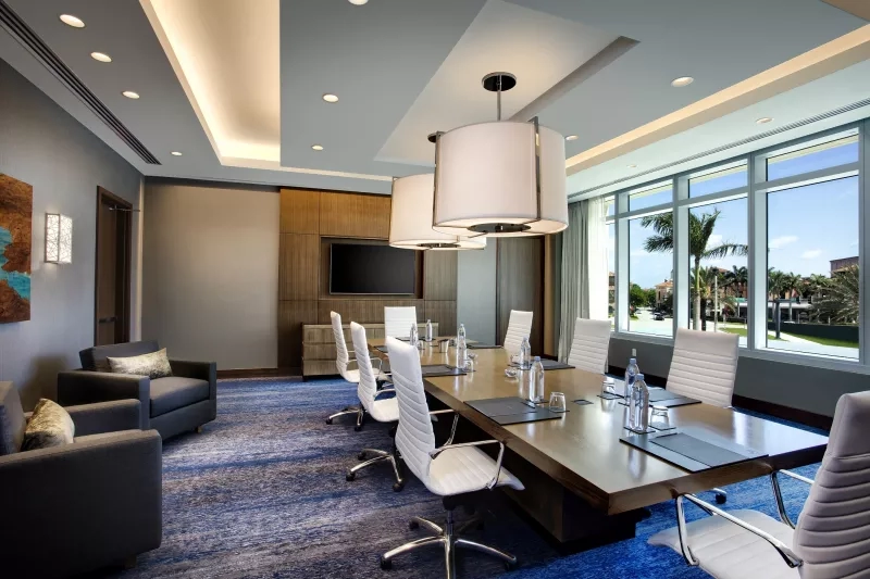 Executive Meetings - Hilton West Palm Beach Executive Boardroom with a large meeting table and chairs.