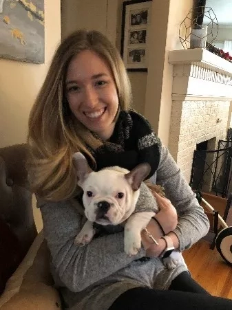 Zoe with her new dog, Oliver, in the living room of her new home.