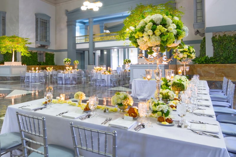 Inside view of beautiful wedding venue with flowers and decorated tables