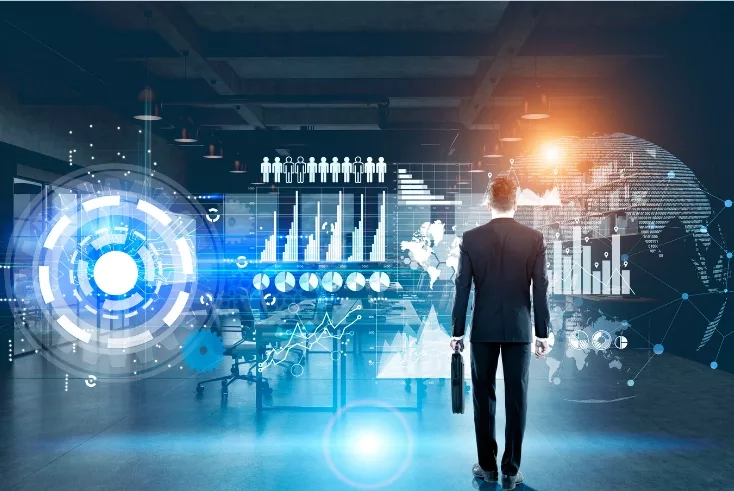 Businessman with briefcase in office with holograms of bar charts, graphs, globe, and gears around him.
