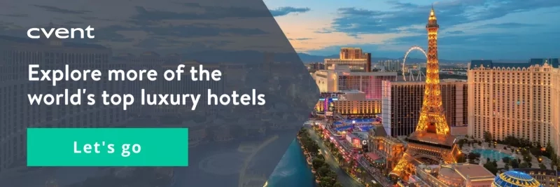 A city skyline with luxury hotels, an Eiffel Tower replica, and a Ferris wheel at dusk.