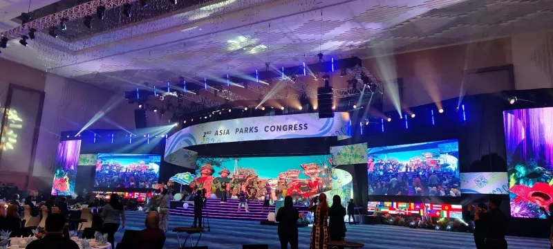 Interior of the ballroom with the 2nd Asia Parks Congress theme and speakers on stage.