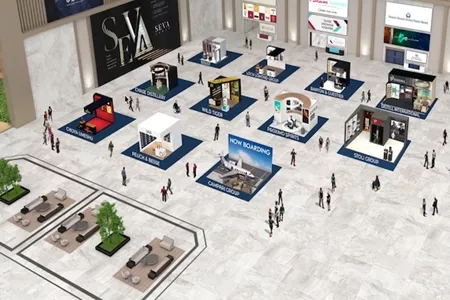 An aerial view of an exhibition hall with several stalls and people walking around the area.