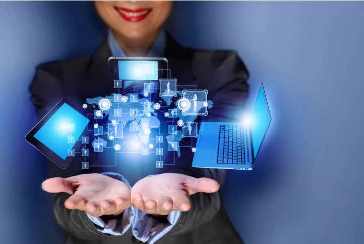 Businesswoman holding technology in hands, depicting a world connected through IT support.