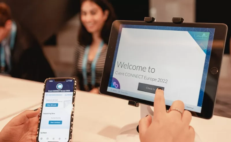 Person checking in at a Cvent event using a tablet and mobile app.