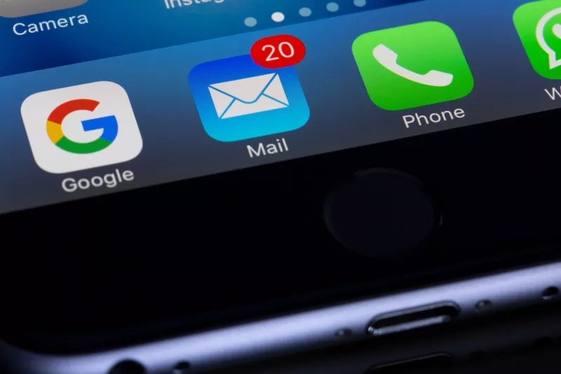 A phone screen showing four icons, Google, Mail, Phone, and Whatsapp, with a 20 badge on Mail.