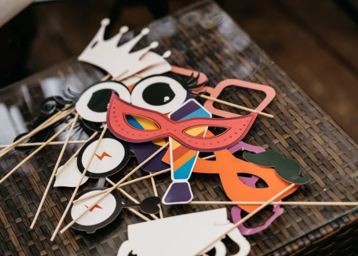 Photo booth props laid out on a table for guests to use at a wedding.