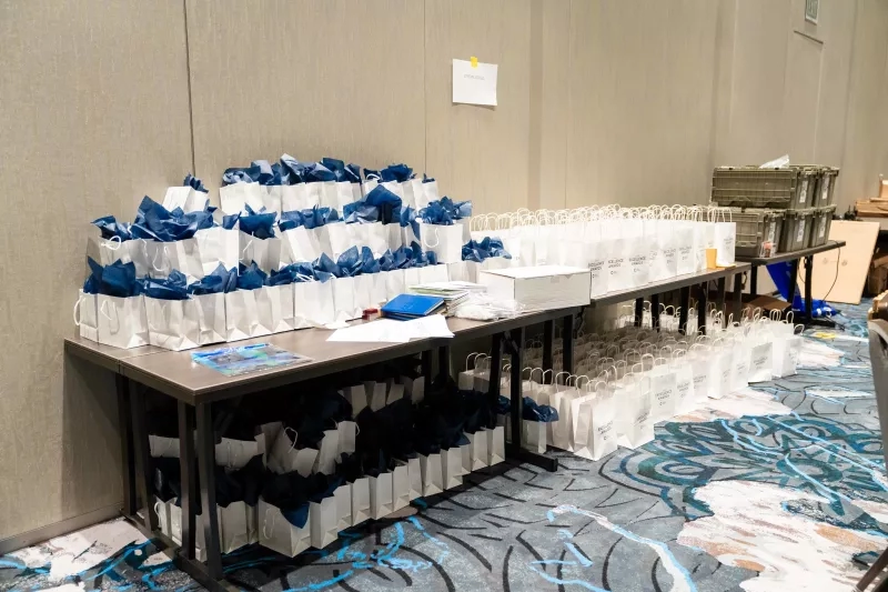 Bags and boxes of business travel swag at Cvent CONNECT 2023 at the Hyatt Regency New Orleans.