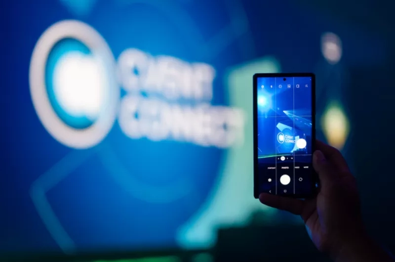 A person holding a smartphone in front of the Cvent Connect logo.
