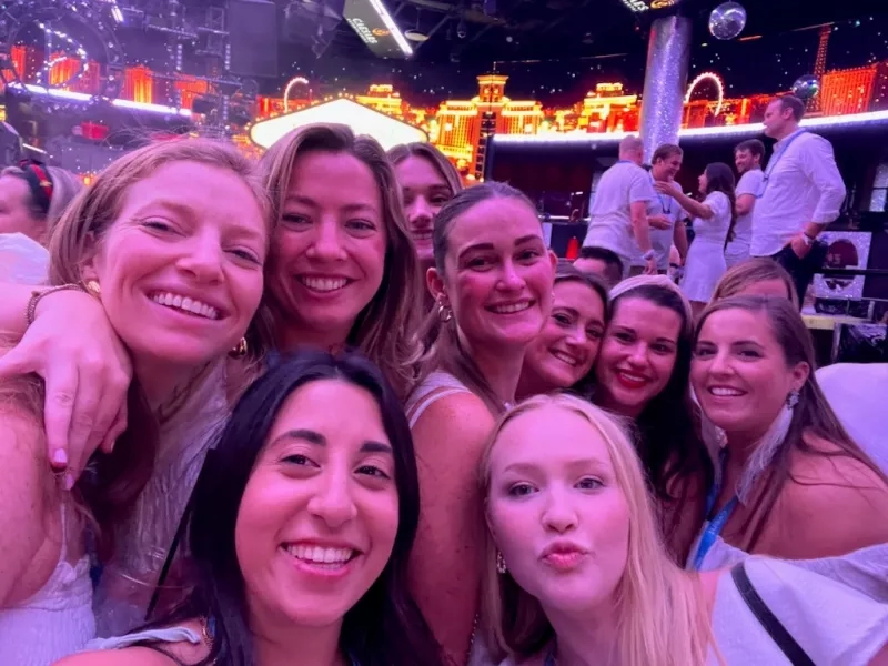 A group of women smiling and posing for a selfie inside a club in Las Vegas.