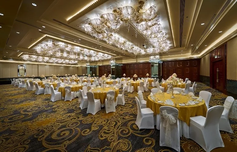 A grand banquet hall with ornate chandeliers and elegant decor in the JW Marriott Hotel Hong Kong.