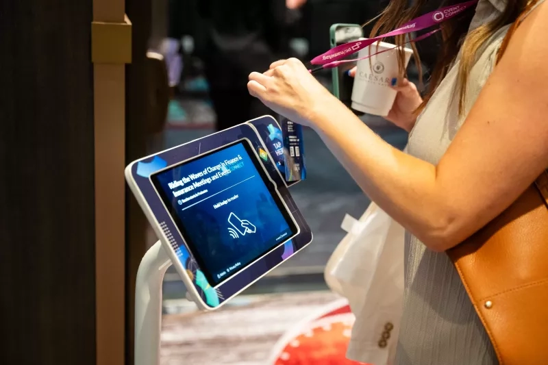 A woman at Cvent Connect 2023 scans her badge to check into a session.