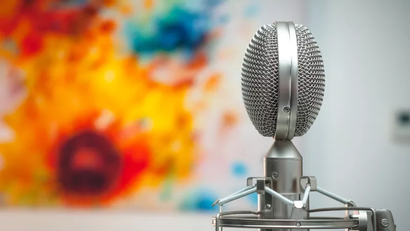 Close up of microphone with colorful abstract painting in the background