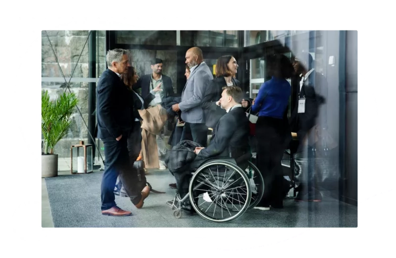 An image of a man in a wheelchair at a networking event.