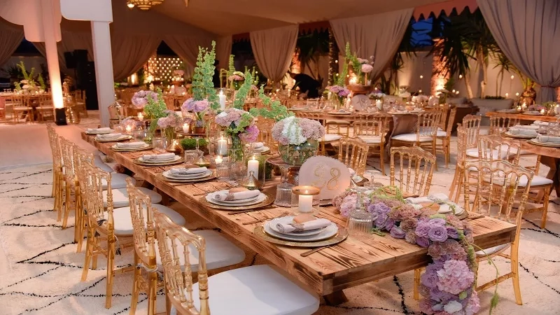 A Moroccan wedding at The Palms in Marrakech with dining tables and chairs.
