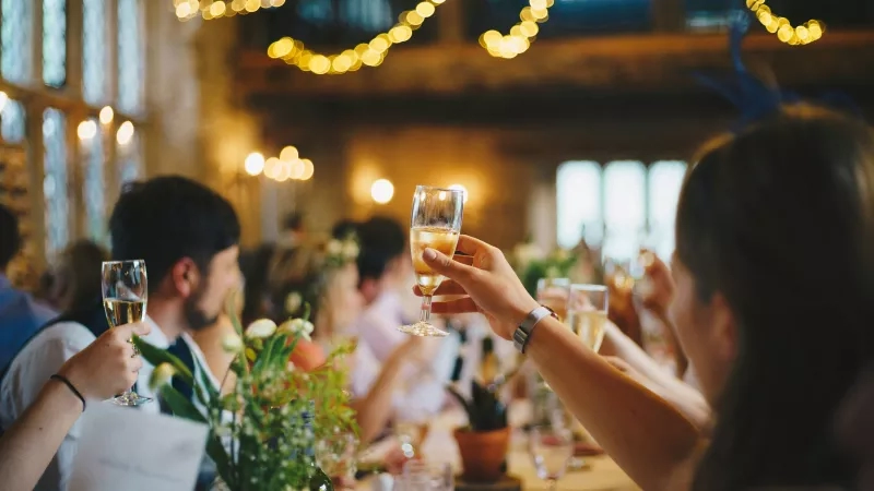 attendees raising glasses at business event