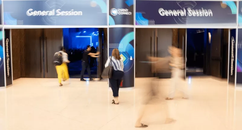Conference theme ideas include a blurred photo of people in a conference room with a blue wall.