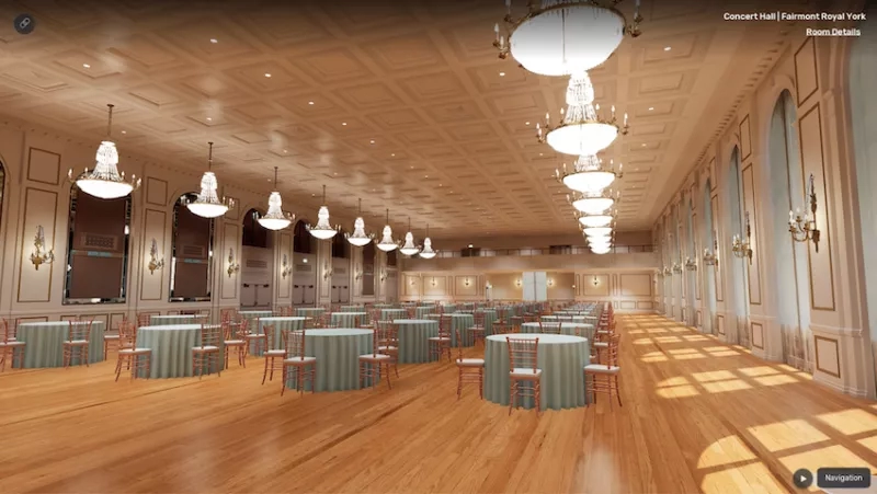 The interior of a large, empty ballroom with round tables and chairs and a ceiling with intricate chandeliers.