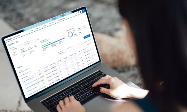 Woman using a laptop with the Cvent dashboard on the screen