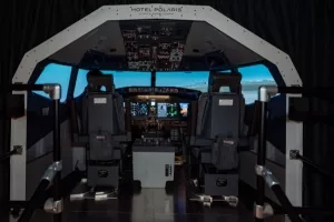 Cockpit of a plane with the Hotel Polaris logo on top of it and black seats.
