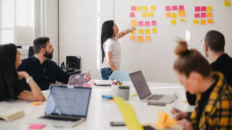 A team of marketers is having a meeting to plan their next event marketing campaign.