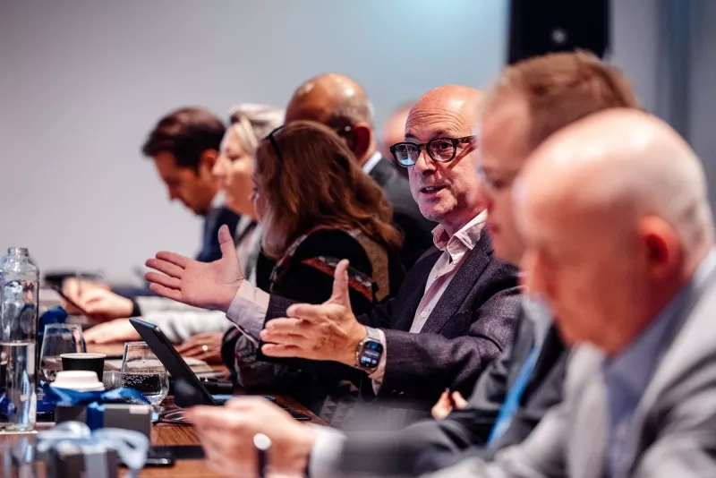 A man is speaking at a meeting with other attendees at Cvent CONNECT 2024.