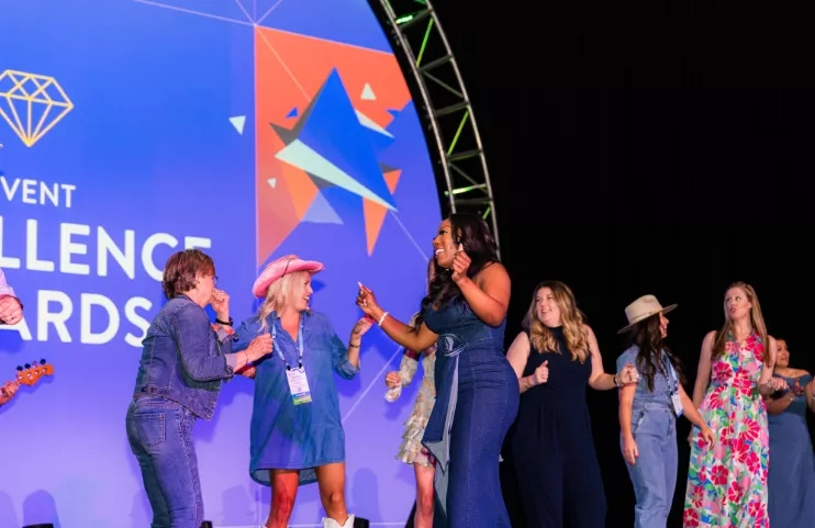 Women celebrating awards on stage