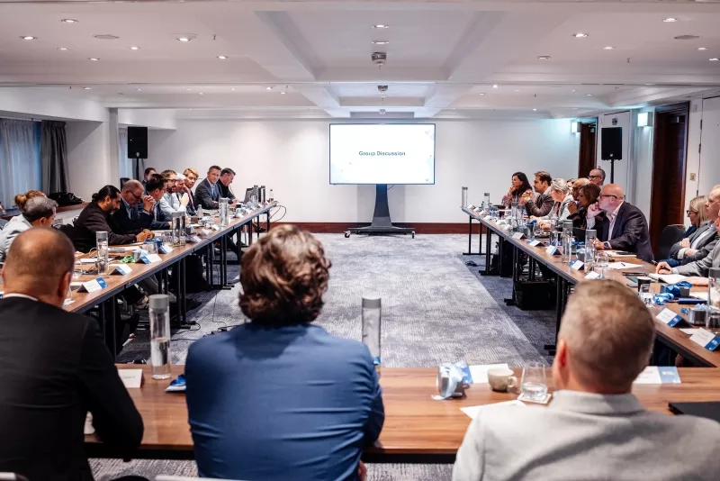 Cvent CONNECT Europe 2024 group discussion in meeting room with large screen and speakers.