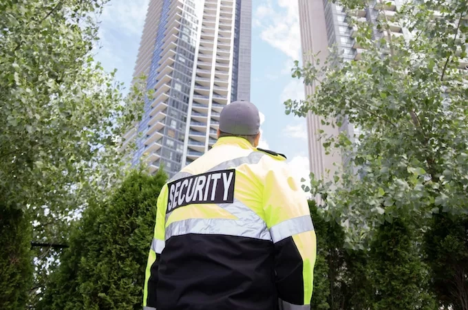 Security officer standing in front of a building in the city.