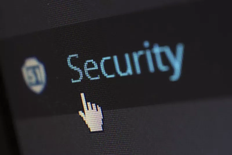 A close-up of a screen showing the word "Security" with a pointing hand icon.