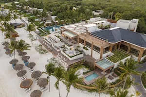 Aerial view of Maykana Beach Club with pool, lounges, and lush greenery in a tropical setting.