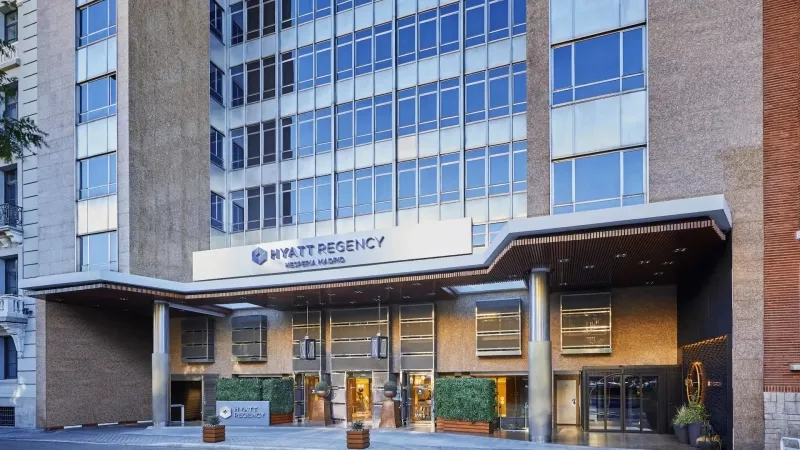 Hyatt Regency Hesperia Madrid hotel entrance with modern architecture and landscaping in the foreground.
