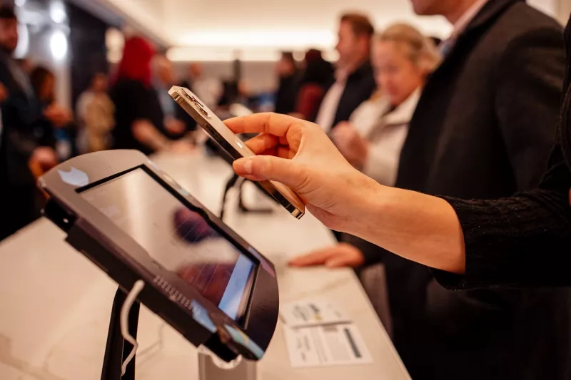 A person is checking in at Cvent CONNECT 2024 using their phone at the conference check-in.
