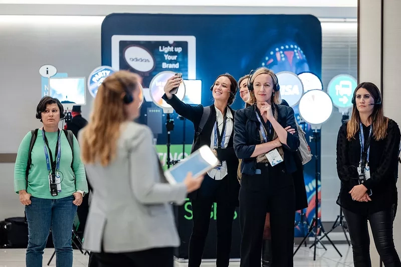 Group of event attendees listening to a speaker in a huddle format 