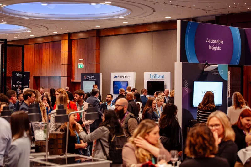 A crowd of people attending the Cvent CONNECT Europe 2024 trade show inside a conference room.