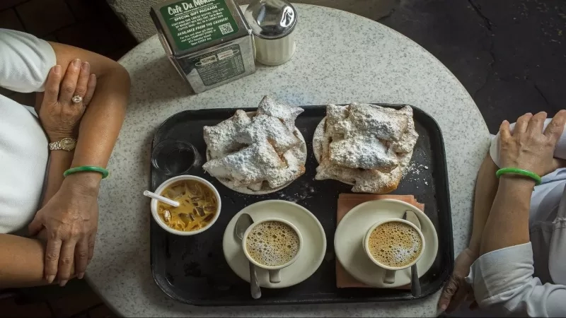 Eat beignets with chicory coffee
