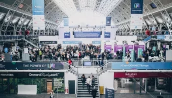 People gathered at an event at a mall with signs that read "The Power of Live" and "Saloni".