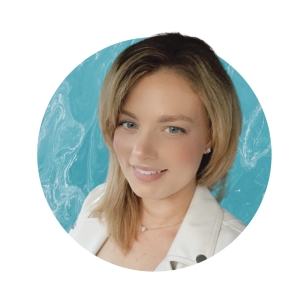 headshot of elizabeth powell wearing a white jacket in front of a blue background