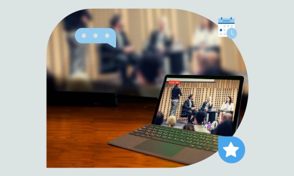 A laptop is open with a screen showing a conference. There are icons for chat, calendar, and star.