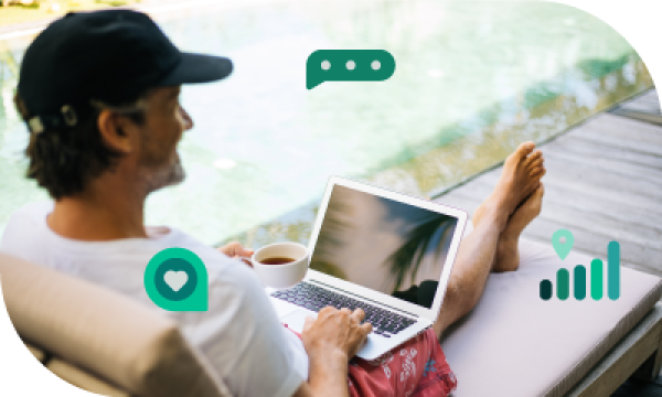 Man in cap sitting on deck chair beside pool with laptop, coffee, and heart icons.