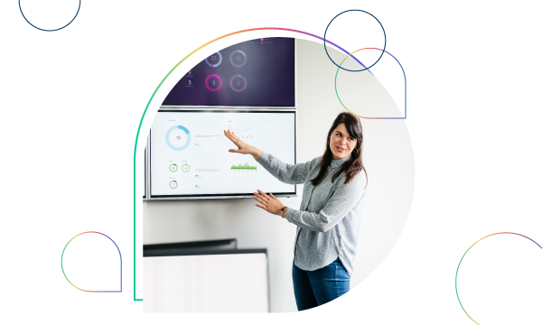 Woman standing in front of a screen giving a presentation with circular icons surrounding her.