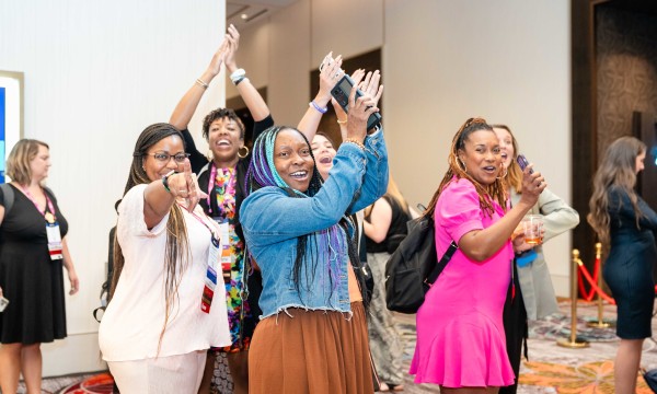 A group of women at Younger Generation Events having fun and dancing with each other.