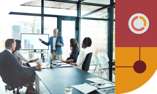Group of business people sitting around a table in meeting room, discussing and collaborating on project.