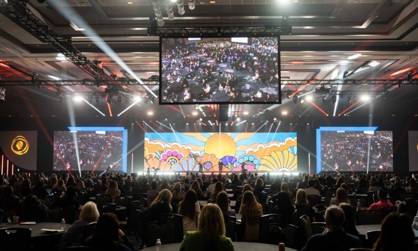 Power of Live Events showing a conference room with large screen and a crowd of people.