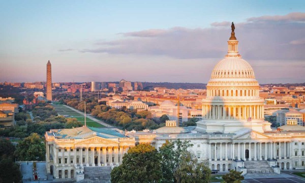Aerial view of the United States Capitol building in Washington, D.C., surrounded by trees and buildings.