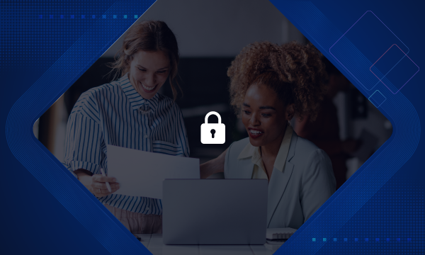 Two women are laughing and looking at a laptop with a lock icon in the center.