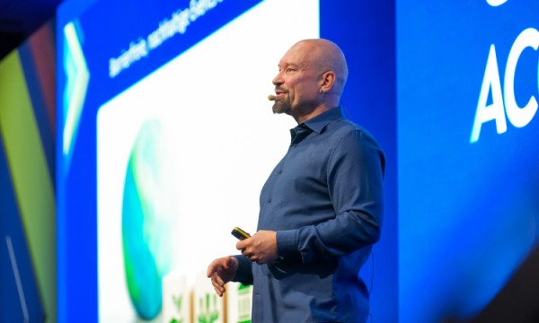 Markus Laibacher speaks at a Cvent Accelerate event in front of a screen that says AC.