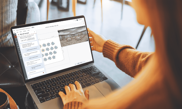 A woman is using a laptop computer to create a virtual tour of a conference center.